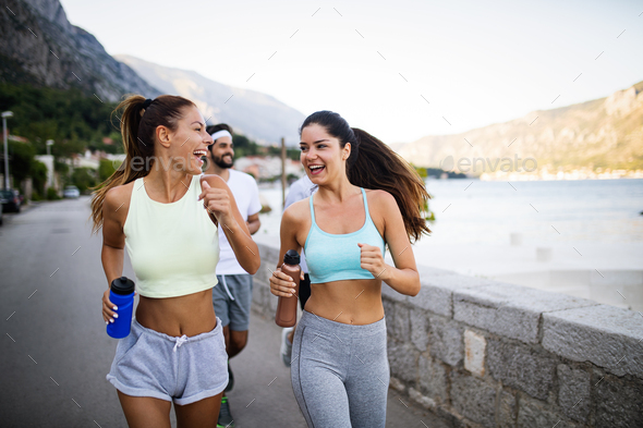 Happy people jogging outdoor. Running sport exercising and healthy lifestyle concept